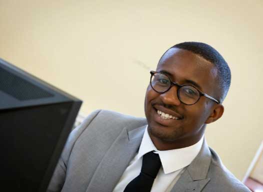 African American man smiling at the camera in a business suit